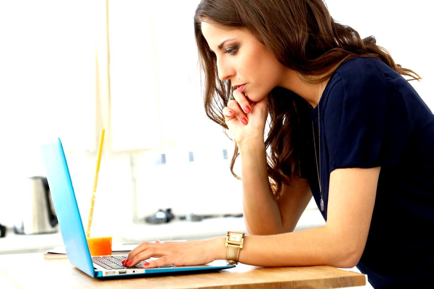 Student working on mobile game development project with Python code visible on screen